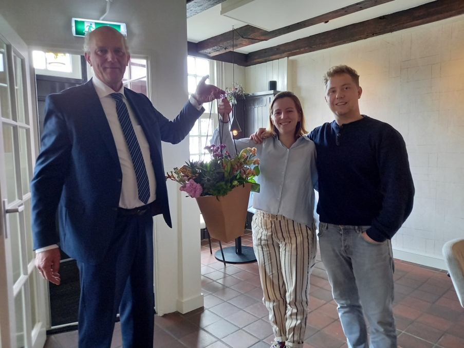 Wethouder van der Maas overhandigt bloemen